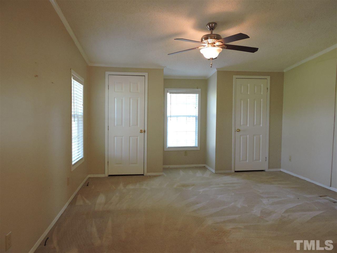 225 Bowling Road Roxboro, NC 27574 - Photo 5 of 19 an empty room with fan and windows
