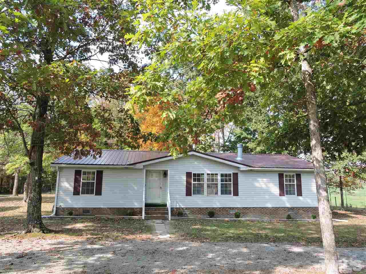 225 Bowling Road Roxboro, NC 27574 - Photo 7 of 19 a house with a tree in front of it