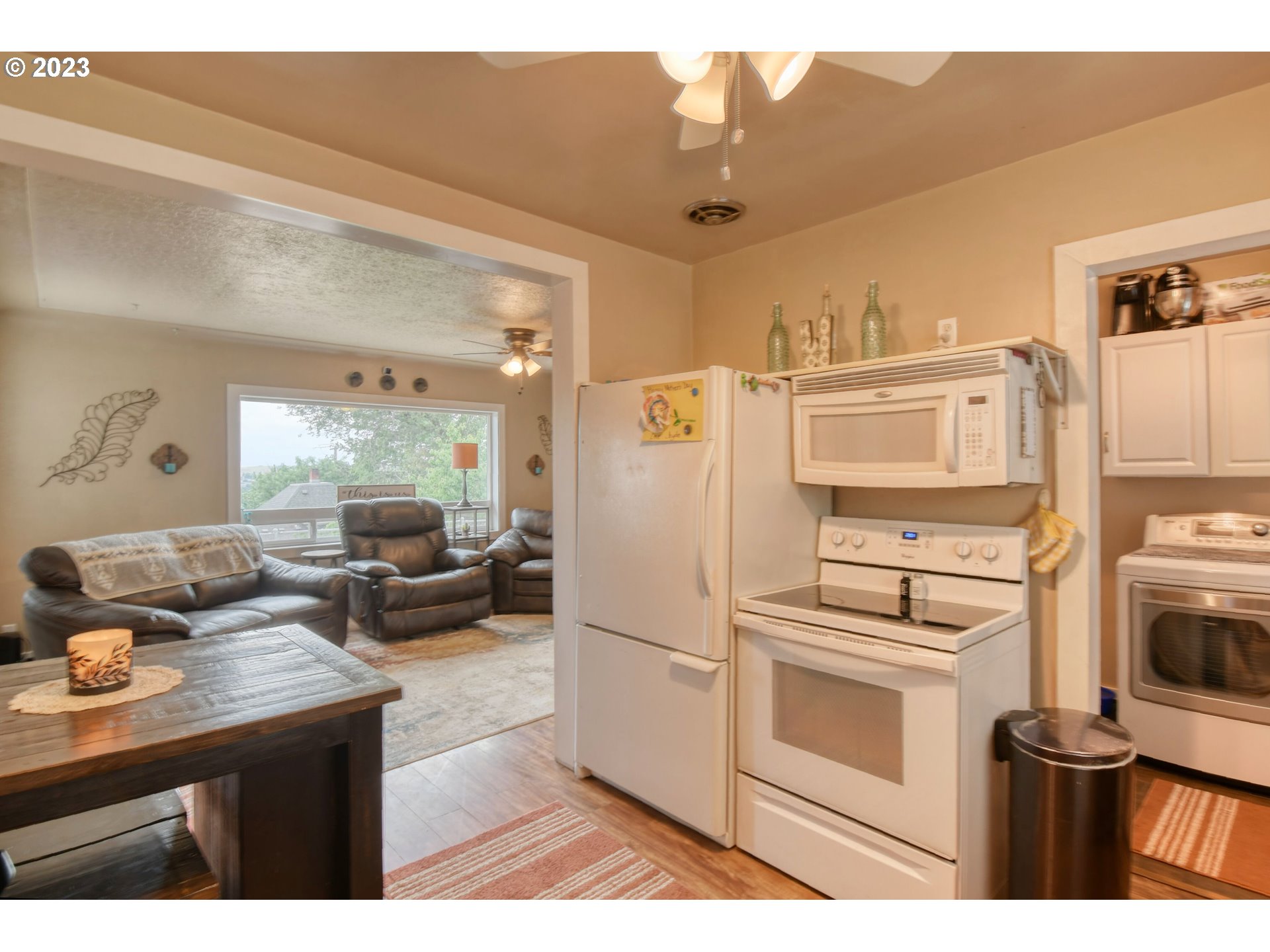 615 Northwest 5th Street Pendleton, OR 97801 - Photo 14 of 33 a kitchen with stainless steel appliances a refrigerator a stove a sink and white cabinets with wooden floor