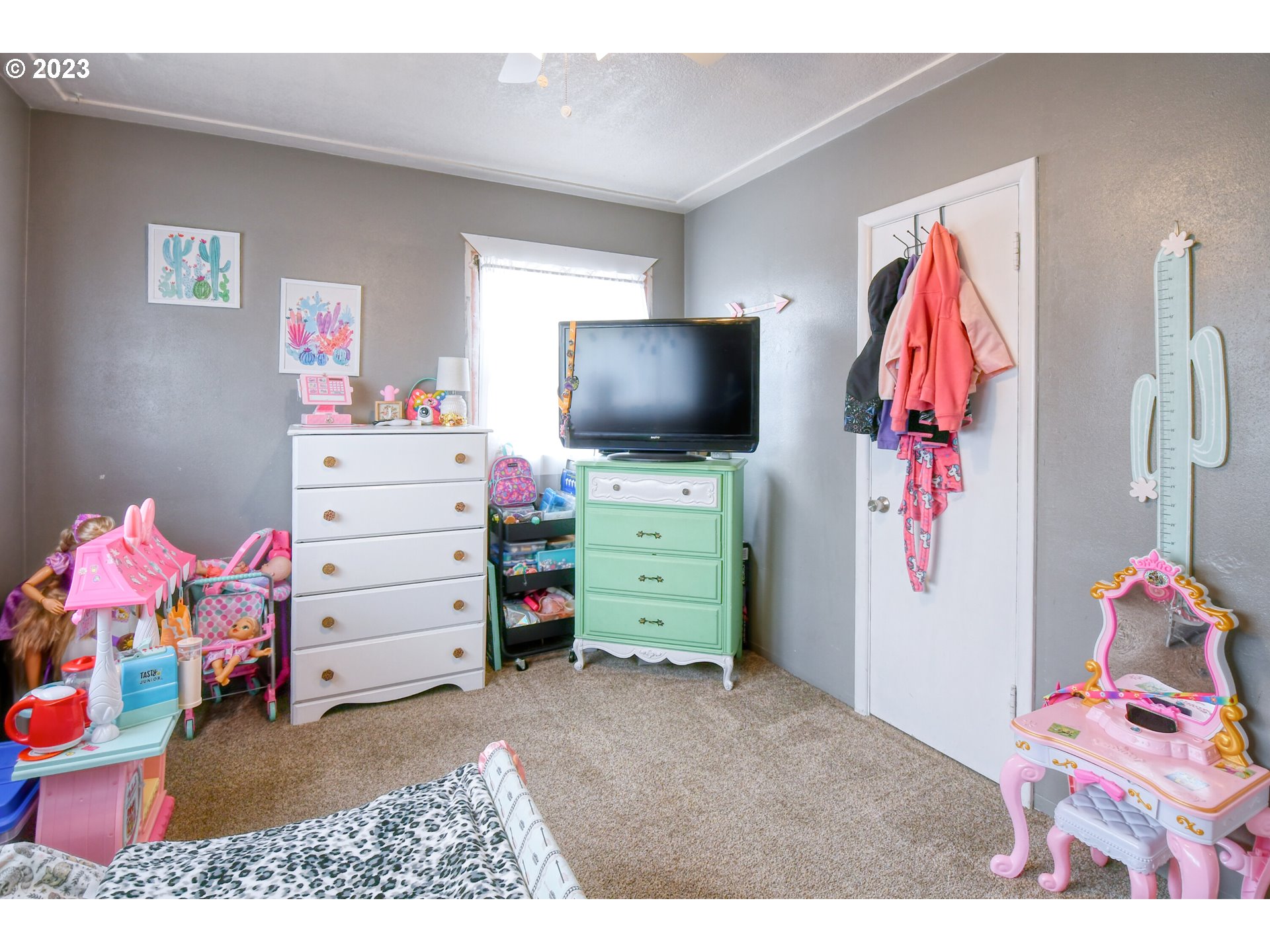 615 Northwest 5th Street Pendleton, OR 97801 - Photo 23 of 33 a bedroom with a baby bed and a flat screen tv
