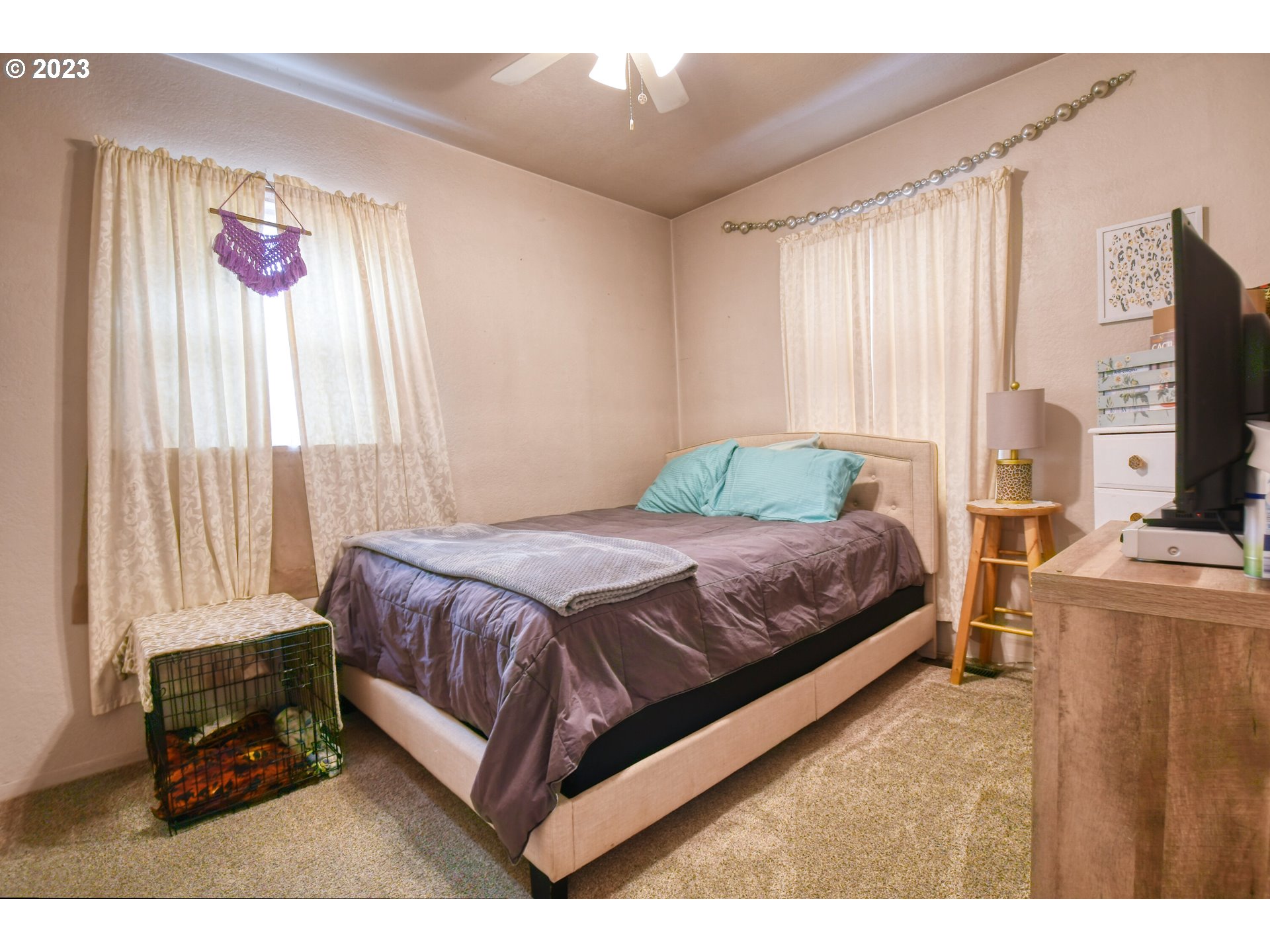 615 Northwest 5th Street Pendleton, OR 97801 - Photo 25 of 33 a bedroom with a bed a flat screen tv and a large window