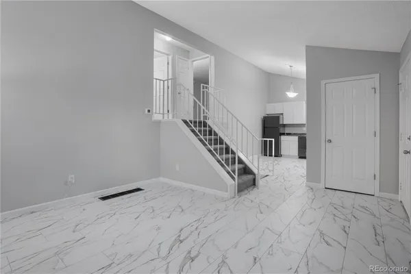 a view of entryway and hall with wooden floor