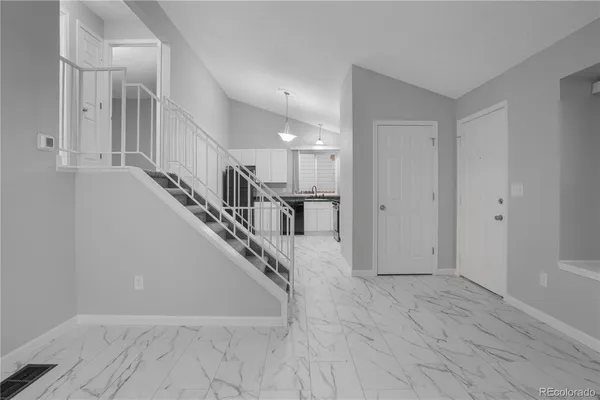a view of an empty room and a fireplace