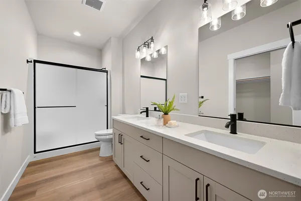 a bathroom with a double vanity sink and a mirror