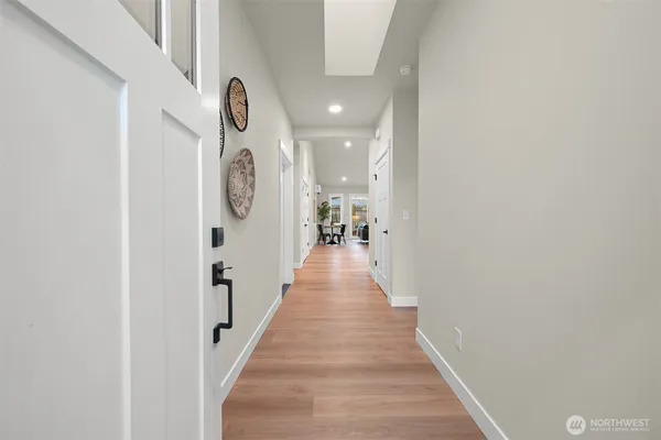 a view of a hallway with wooden floor