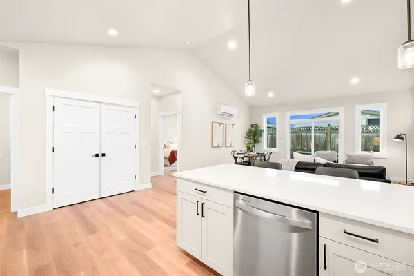 a kitchen with stainless steel appliances a sink stove and cabinets