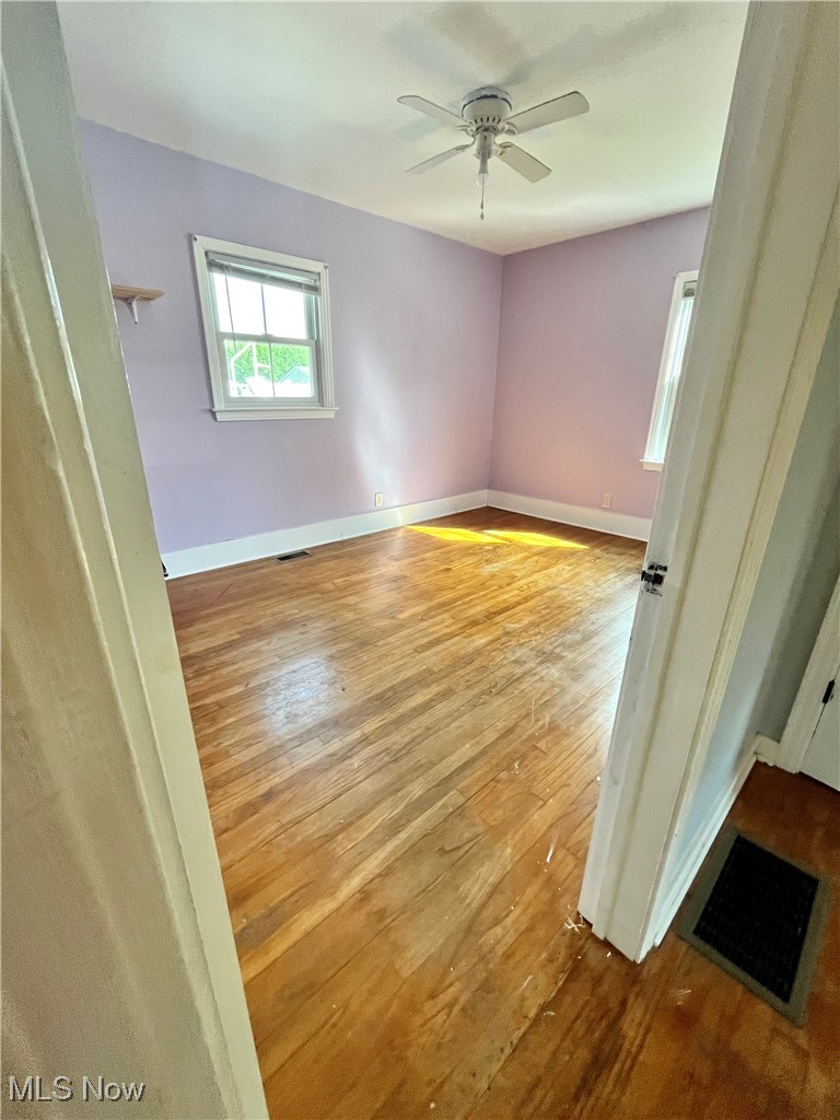 5775 Oberlin Road Amherst, OH 44001 - Photo 10 of 36 bedroom with hardwood floors and ceiling fan