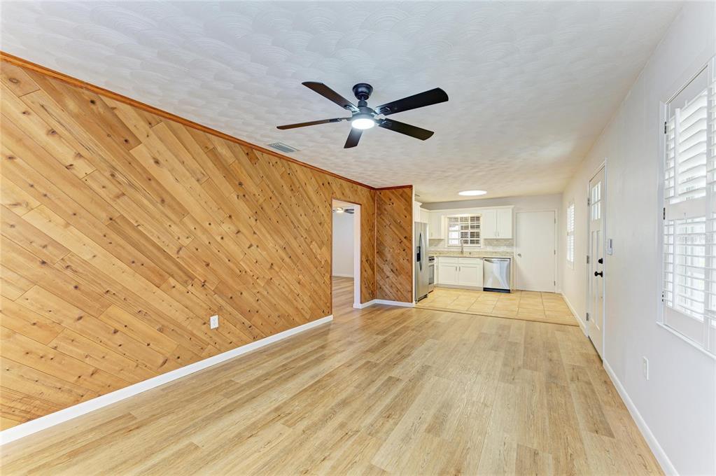616 Palm Avenue Ellenton, FL 34222 - Photo 15 of 53 a view of a livingroom with wooden floor and a ceiling fan
