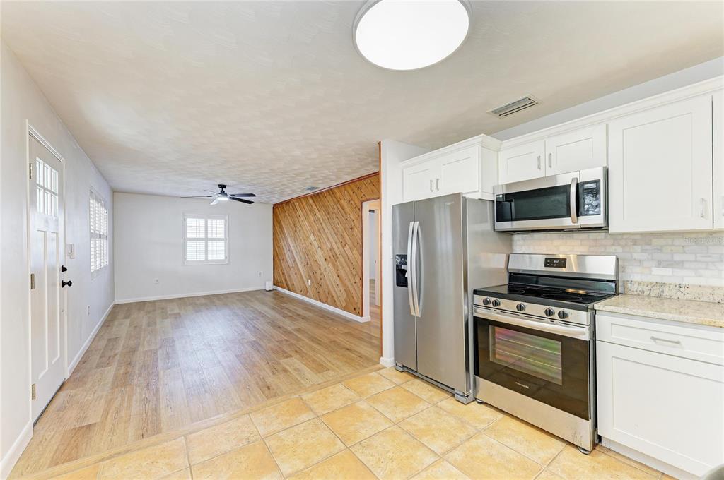 616 Palm Avenue Ellenton, FL 34222 - Photo 16 of 53 a kitchen with granite countertop a stove a sink and a refrigerator