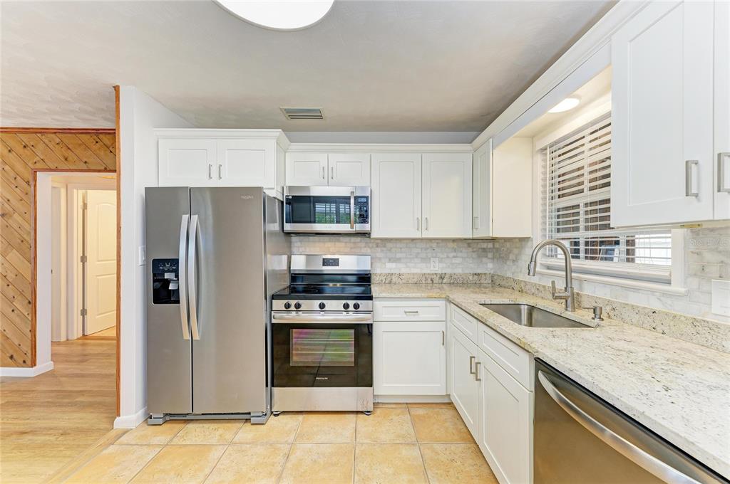 616 Palm Avenue Ellenton, FL 34222 - Photo 19 of 53 a kitchen with stainless steel appliances granite countertop a refrigerator sink and stove