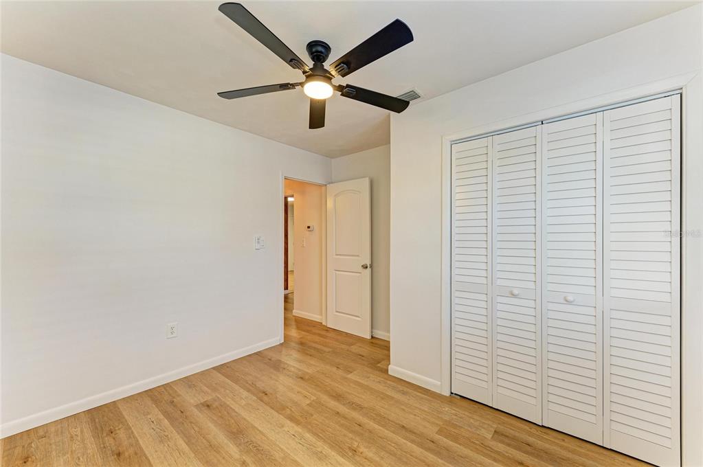 616 Palm Avenue Ellenton, FL 34222 - Photo 20 of 53 an empty room with wooden floor and ceiling fan