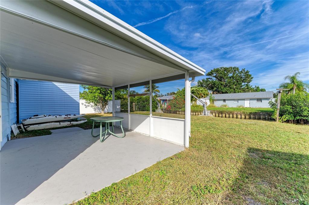 616 Palm Avenue Ellenton, FL 34222 - Photo 46 of 53 a view of a patio with table and chairs under an umbrella