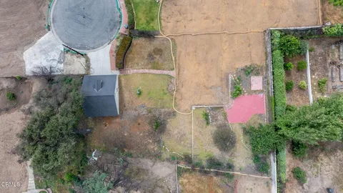 an aerial view of residential house with outdoor space and swimming pool