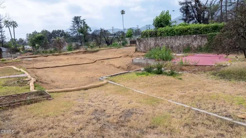 a view of a yard with large trees