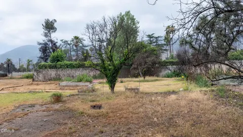 a view of a yard with swimming pool