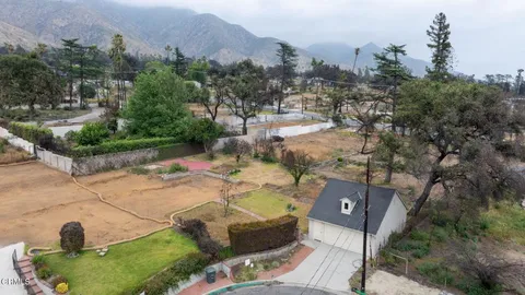 a view of a chairs and table in the backyard