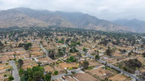 an aerial view of residential house and covered with trees