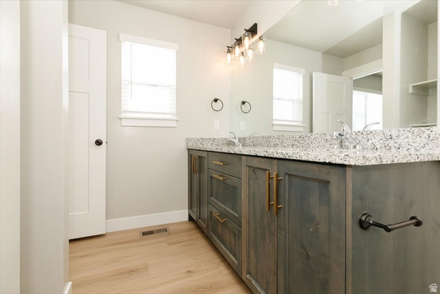 226 South 600 West Logan, UT 84321 - Photo 22 of 25 Bathroom with double vanity, plenty of natural light, and light wood finished floors