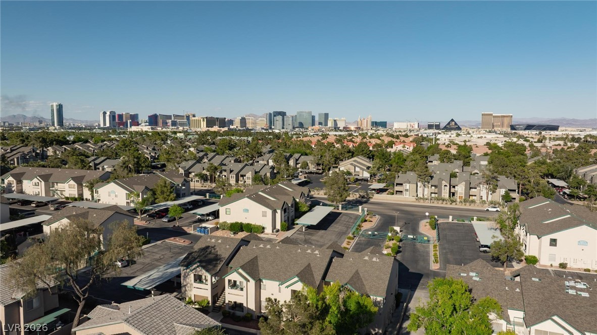 5171 South Lindell Road, Unit 103 Las Vegas, NV 89118 - Photo 24 of 24 An aerial perspective reveals a vibrant neighborhood with a dynamic city skyline in the distance.