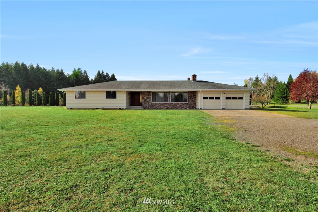 433 Curtis Hill Road Chehalis, WA 98532 - Photo 1 of 22 a view of a house with a big yard and large trees