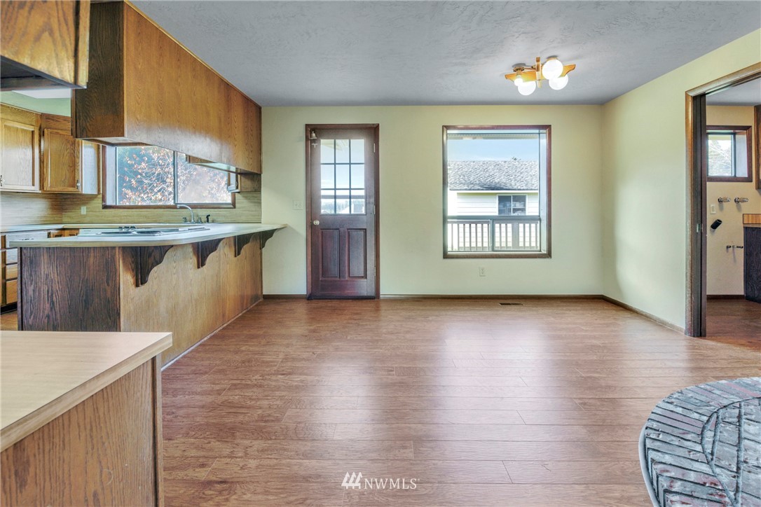 433 Curtis Hill Road Chehalis, WA 98532 - Photo 13 of 22 a view of a kitchen with kitchen island a sink wooden floor and a large window