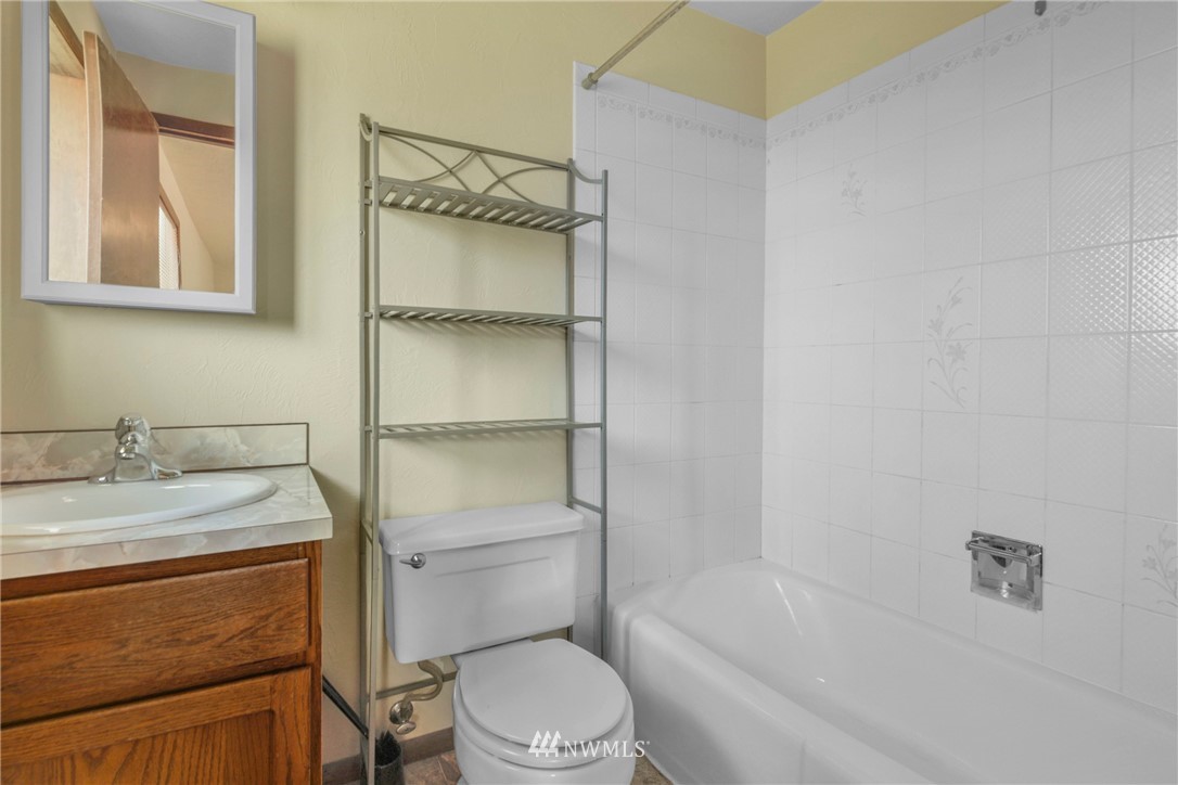 433 Curtis Hill Road Chehalis, WA 98532 - Photo 16 of 22 a bathroom with a granite countertop toilet sink and mirror
