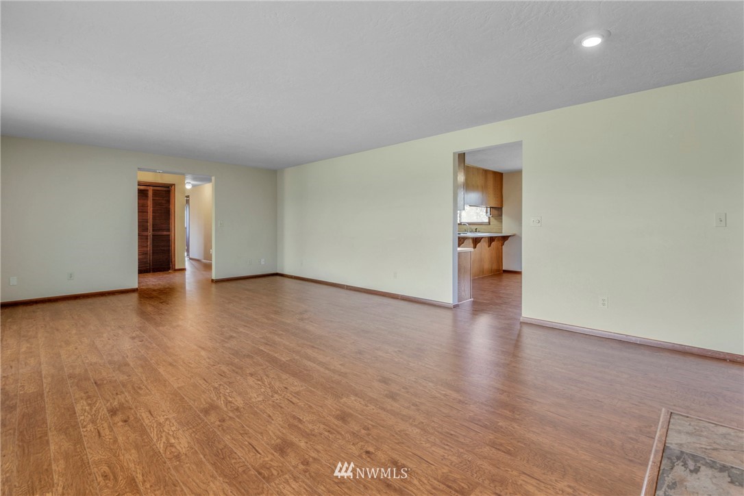 433 Curtis Hill Road Chehalis, WA 98532 - Photo 8 of 22 a view of empty room with wooden floor and kitchen