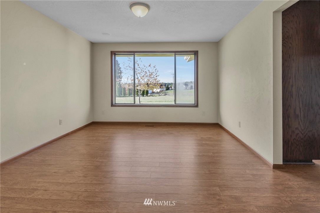 433 Curtis Hill Road Chehalis, WA 98532 - Photo 9 of 22 an empty room with wooden floor and windows