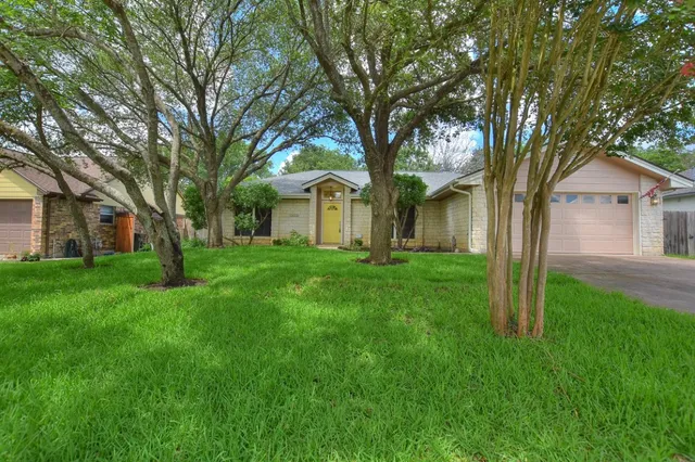 a front view of house with yard and green space