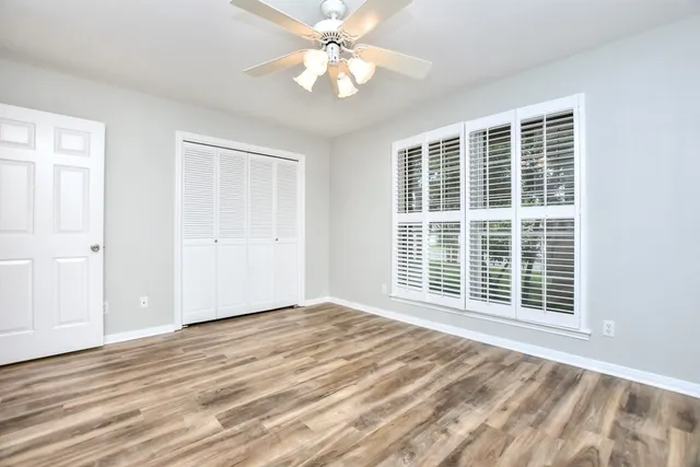 a view of a room with a ceiling fan and a window