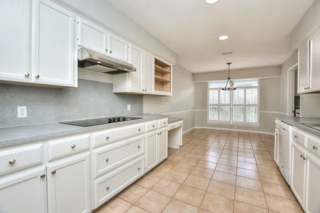 a kitchen with a sink window and cabinets