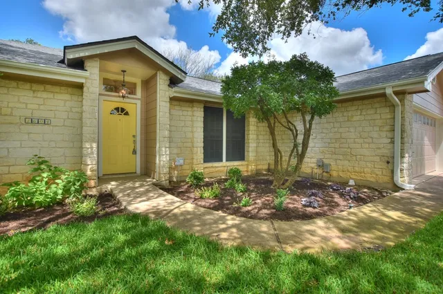 a front view of a house with garden
