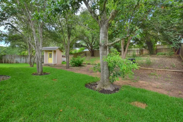 a view of backyard of house with green space