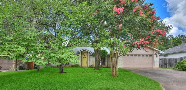 a front view of house with yard and green space