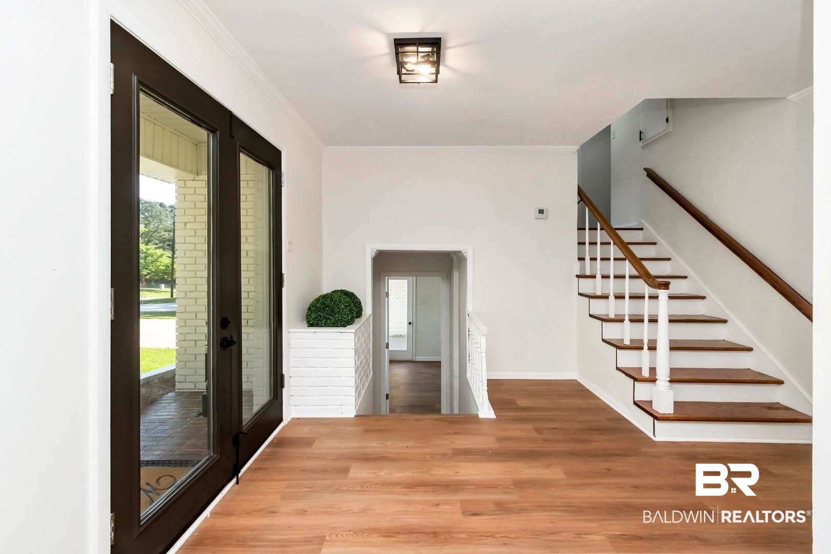 115 Pineridge Road Daphne, AL 36526 - Photo 3 of 34 Foyer entrance with stairway, baseboards, crown molding, and wood finished floors