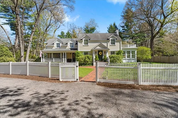 a front view of a house with a garden and plants
