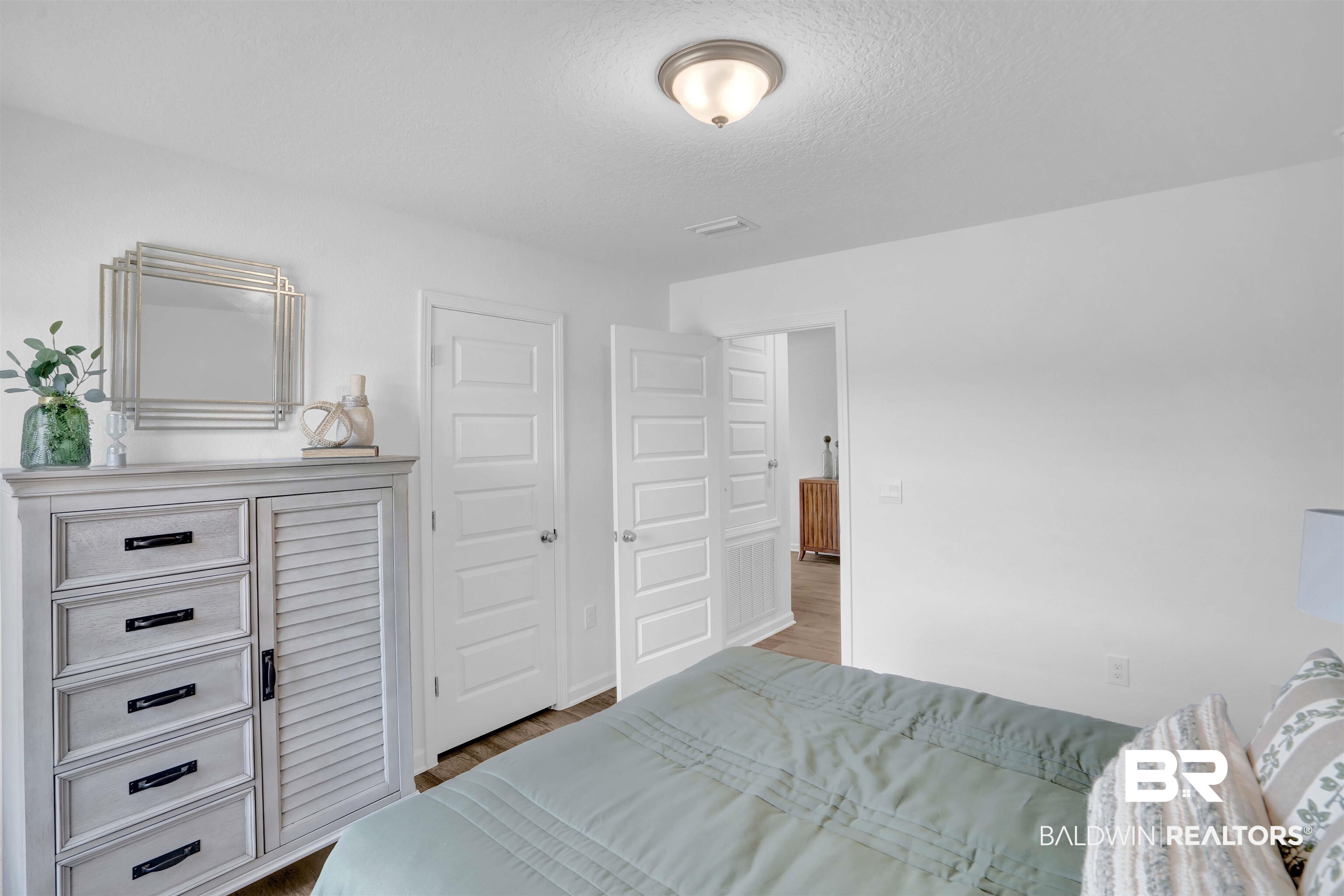 14717 Dayton Circle Foley, AL 36535 - Photo 13 of 39 Bedroom with wood-type flooring and a textured ceiling