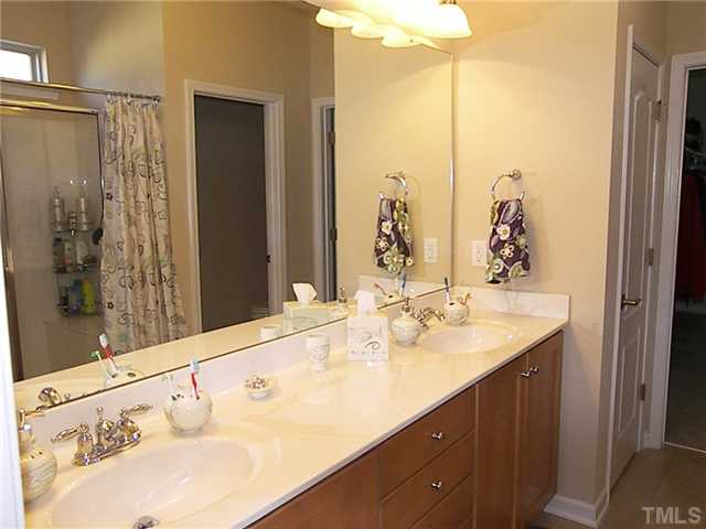 2765 Cashlin Drive Raleigh, NC 27616 - Photo 11 of 25 The master bath has an adult height vanity with dual sinks, extra large shower with seat, and an elevated and elongated commode in the water closet.