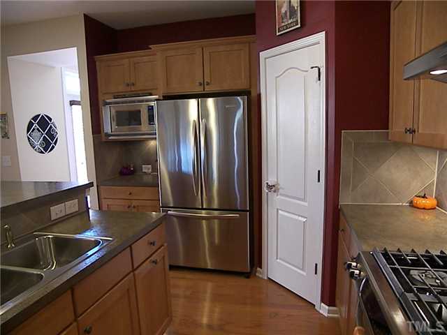2765 Cashlin Drive Raleigh, NC 27616 - Photo 18 of 25 The gas stove is an Architect Series II KitchenAid. Quality. Notice the built in microwave to the left of the refrigerator and the double sink on the island. The door leads to a sizable pantry, and check out all the cabinets!