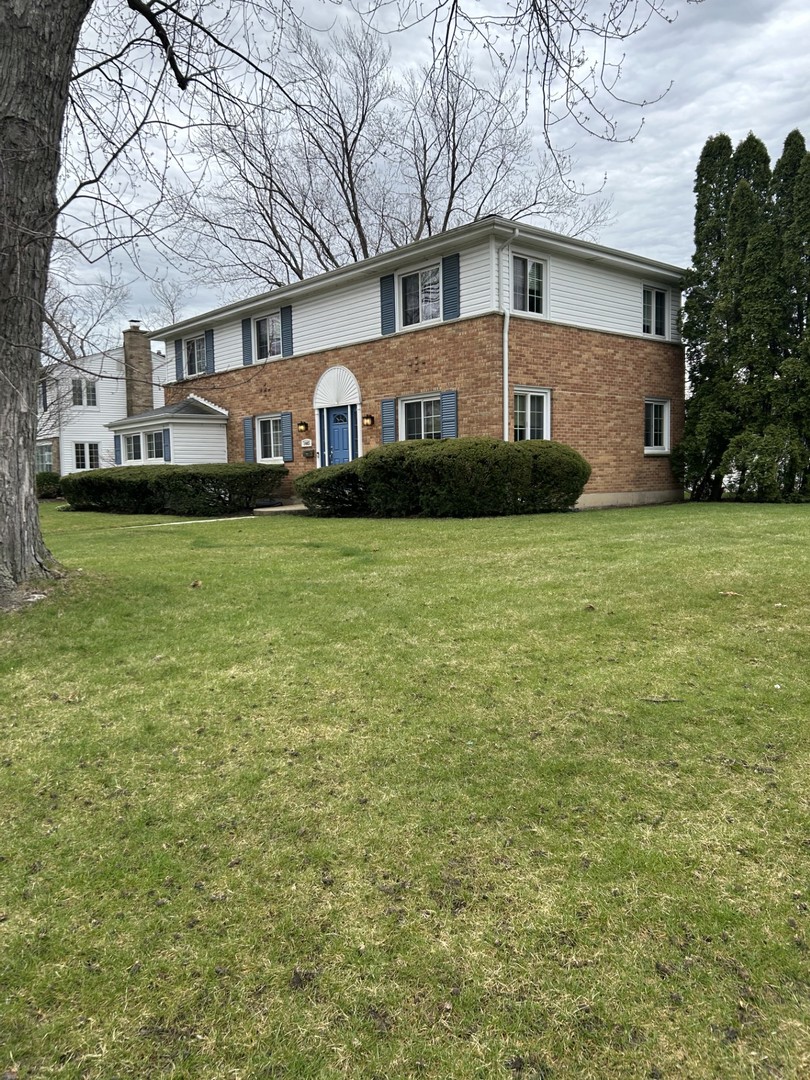 1445 Hackberry Road Deerfield, IL 60015 - Photo 3 of 6 a front view of a house with garden