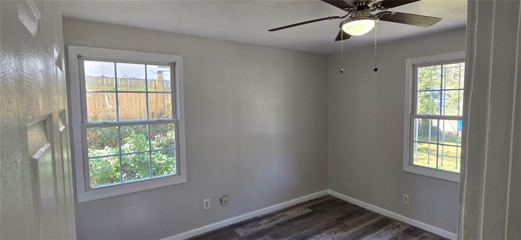 1280 Elizabeth Avenue Southwest Atlanta, GA 30310 - Photo 4 of 9 an empty room with a window and ceiling fan