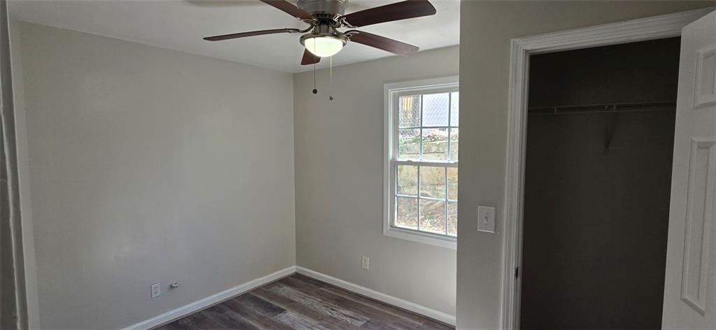 1280 Elizabeth Avenue Southwest Atlanta, GA 30310 - Photo 5 of 9 an empty room with windows and fan