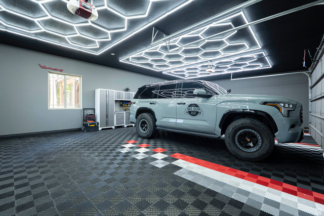687 South 2080th Street East Springville, UT 84663 - Photo 64 of 149 Garage interior featuring hexagonal ceiling lighting, gray walls, and a window with security bars