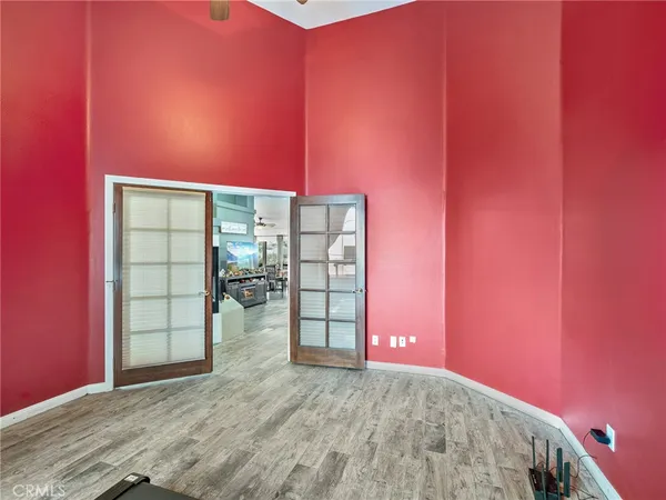 a view of a room with wooden floor and windows
