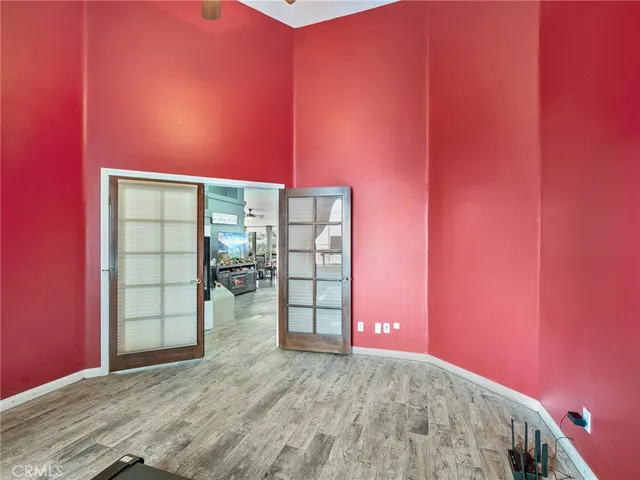 a view of a room with wooden floor and windows