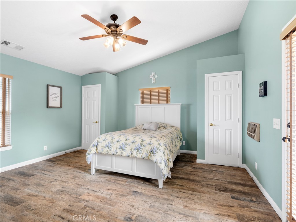 10160 Pineview Road Pinon Hills, CA 92372 - Photo 16 of 46 a bedroom with a bed and a chandelier