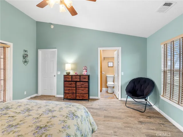 a bedroom with a bed and a chair