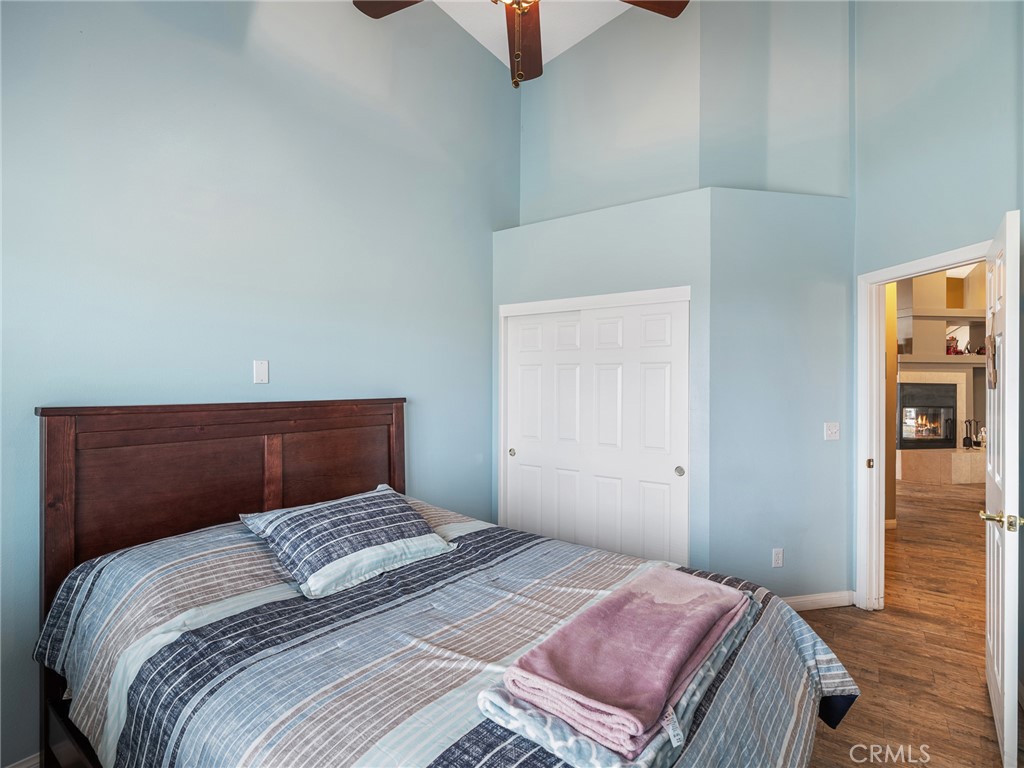 10160 Pineview Road Pinon Hills, CA 92372 - Photo 20 of 46 a bedroom with a bed and wooden floor