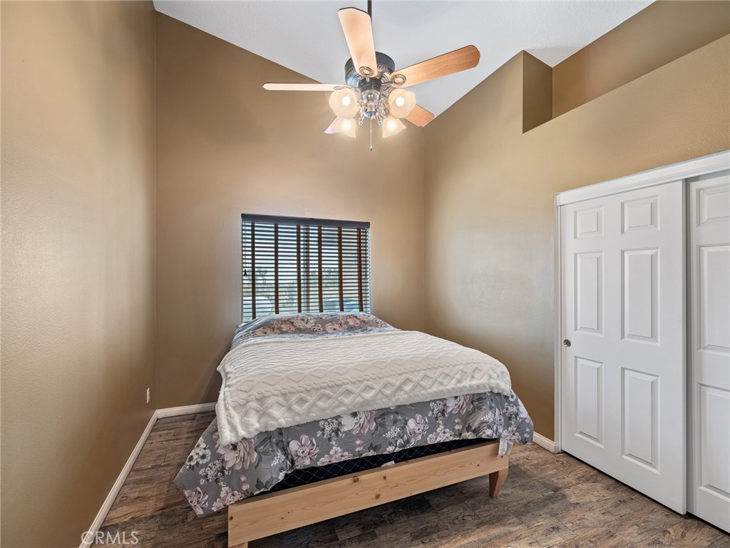 10160 Pineview Road Pinon Hills, CA 92372 - Photo 21 of 46 a bedroom with a bed and a chandelier