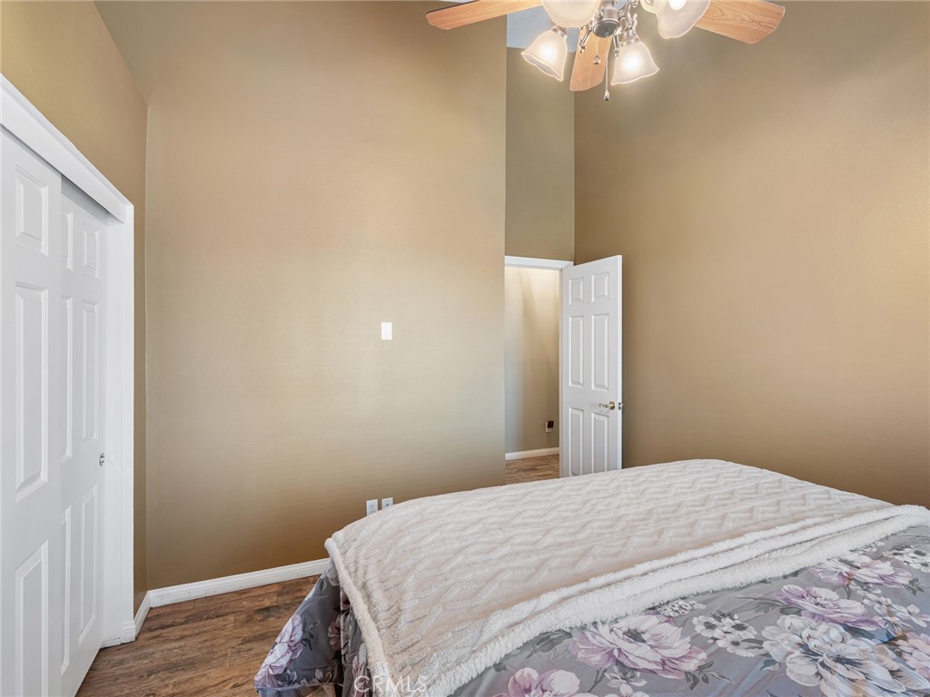 10160 Pineview Road Pinon Hills, CA 92372 - Photo 22 of 46 a bedroom with a bed and a chandelier